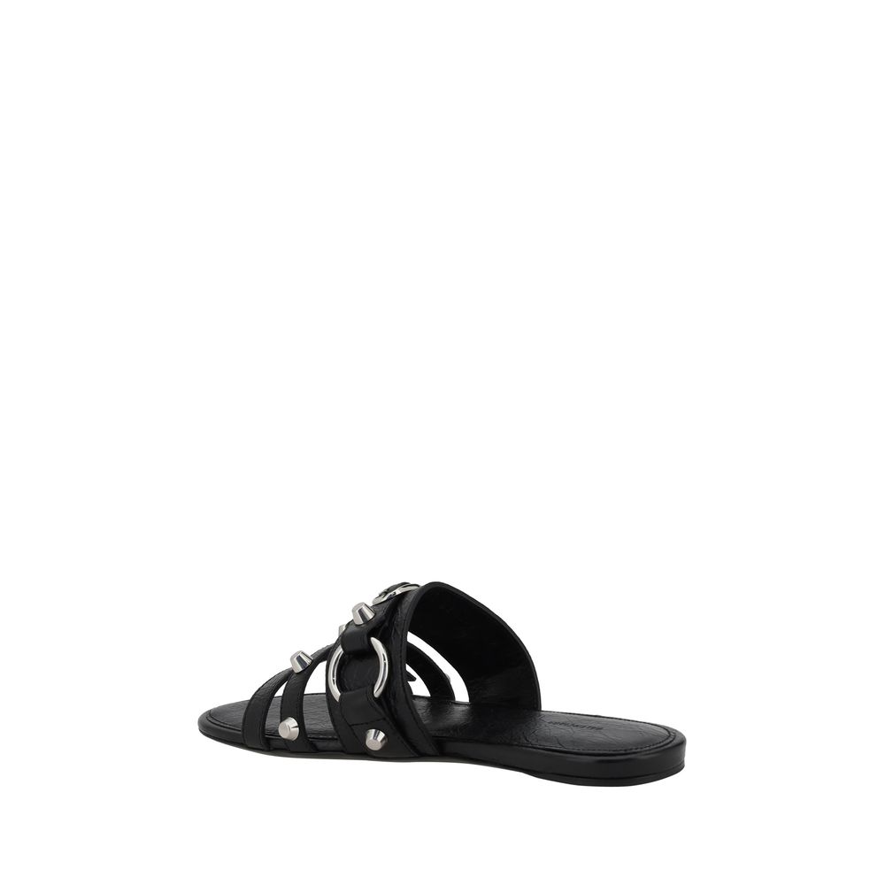Black Calf Leather Bos Taurus Flat SandalsBalenciaga’s studded Sandals combine a bold and sophisticated design. A slip-on model with a flat sole, they feature three front straps decorated with silver studs and rings, giving them a modern, rock look. These