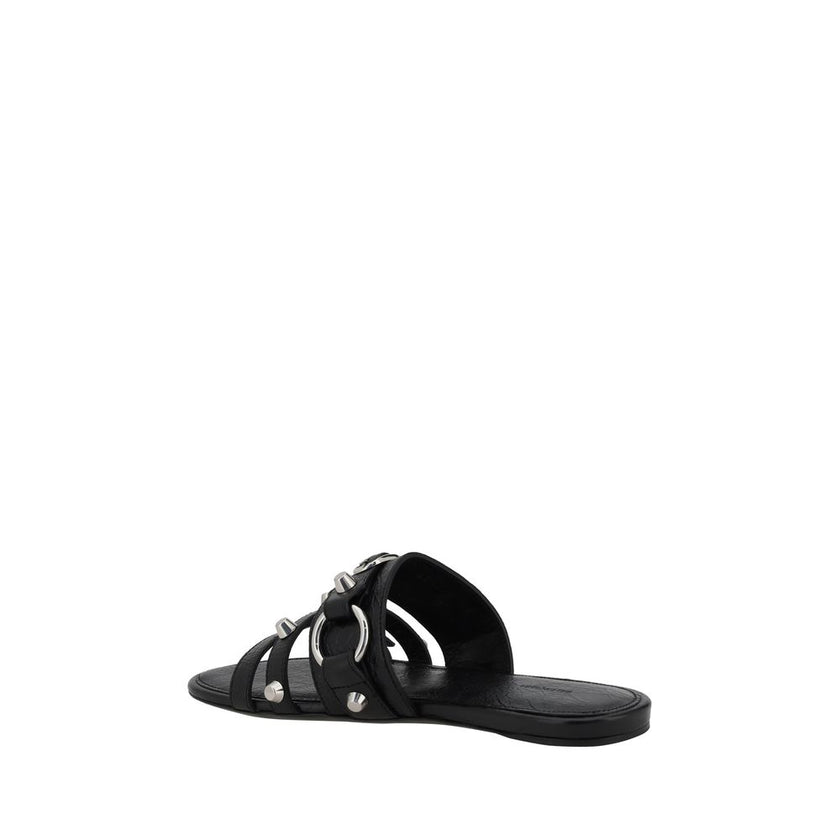 Black Calf Leather Bos Taurus Flat SandalsBalenciaga’s studded Sandals combine a bold and sophisticated design. A slip-on model with a flat sole, they feature three front straps decorated with silver studs and rings, giving them a modern, rock look. These