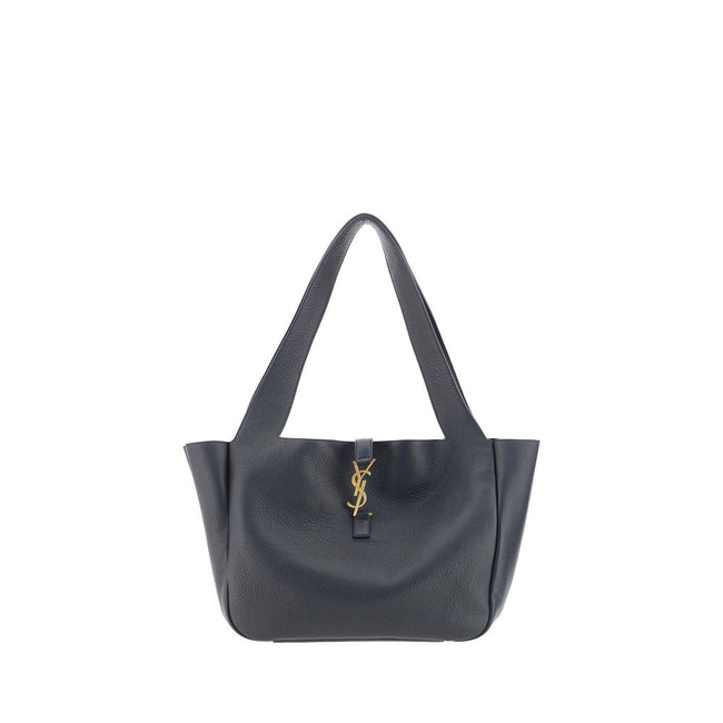 Black Leather Shoulder BagThe Le 5 À 7 Bea Leather Shoulder Bag by Saint Laurent is crafted from fine deerskin leather with an essential and sophisticated design. The top flap closure is embellished with a three-dimensional plaque featuring the iconic YSL