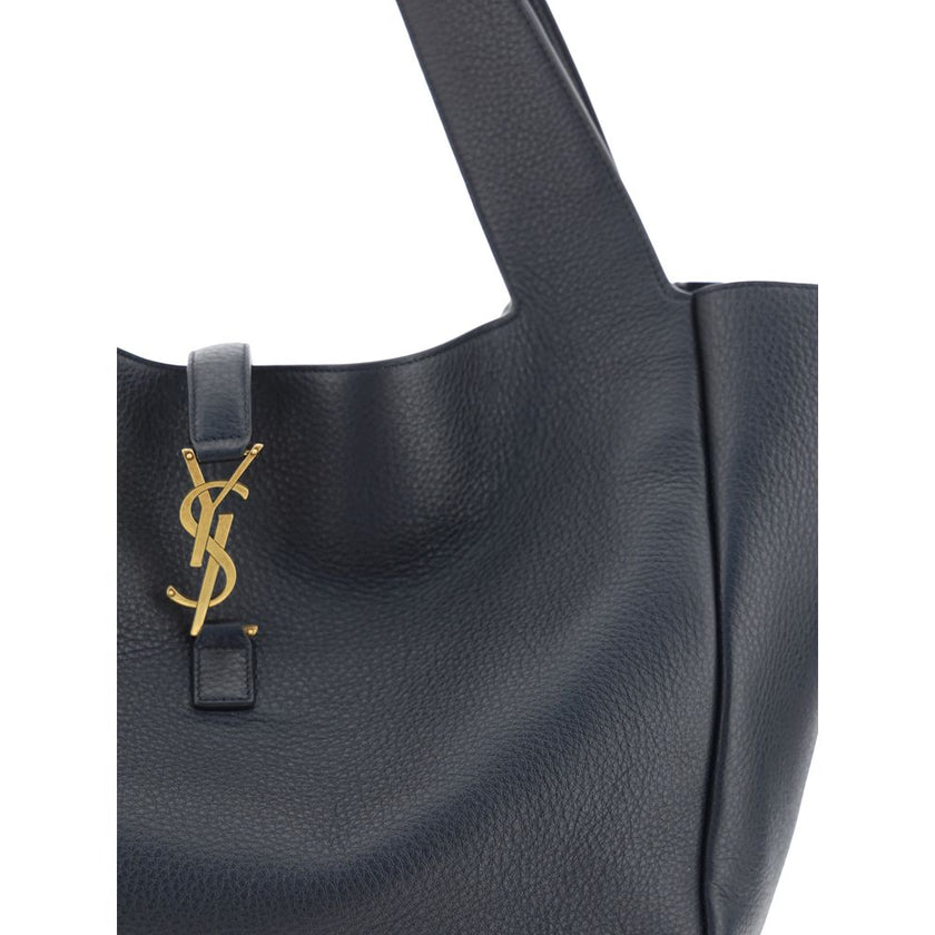 Black Leather Shoulder BagThe Le 5 À 7 Bea Leather Shoulder Bag by Saint Laurent is crafted from fine deerskin leather with an essential and sophisticated design. The top flap closure is embellished with a three-dimensional plaque featuring the iconic YSL