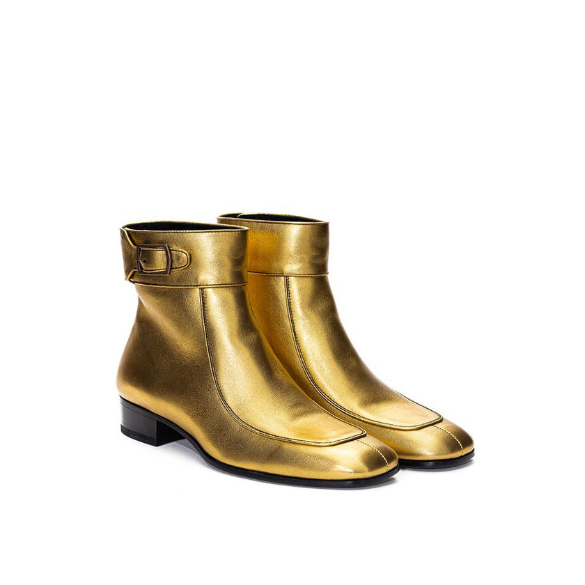 Gold Leather Ankle BootsGold Leather Ankle Boot Saint Laurent. Made of gold-colored leather, square toe, visible stitching, strap with buckle above the ankle, rear zipper, black leather outsole. Heel height: 3 cm. Composition: 100% Leather. Internal SKU: