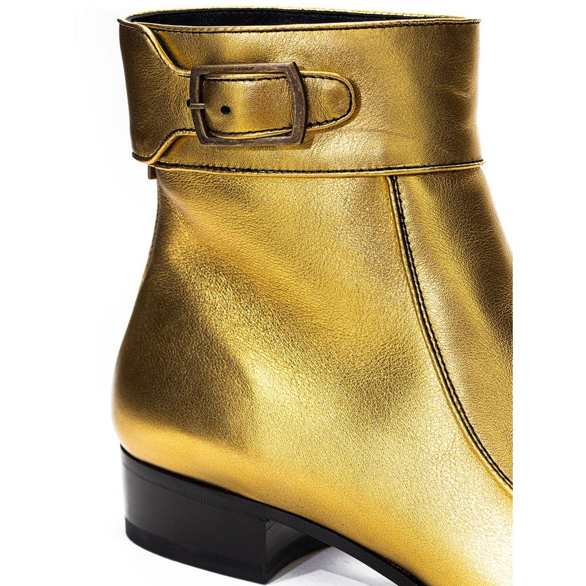 Gold Leather Ankle BootsGold Leather Ankle Boot Saint Laurent. Made of gold-colored leather, square toe, visible stitching, strap with buckle above the ankle, rear zipper, black leather outsole. Heel height: 3 cm. Composition: 100% Leather. Internal SKU: