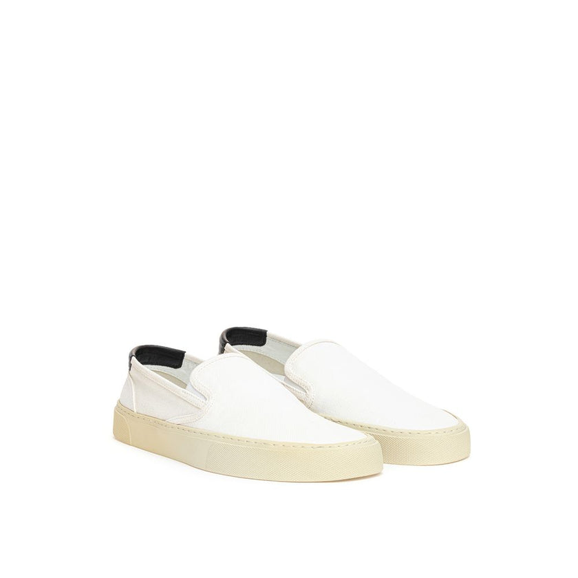 White Cotton Low Top SneakersWhite Canvas Slip-On Saint Laurent. Venice slip-on in cotton canvas, tone-on-tone rubber sole, round toe, black leather back tab with logo. Printed logo on the back. Sole height: 3 cm. Composition: 100% Cotton, leather interio