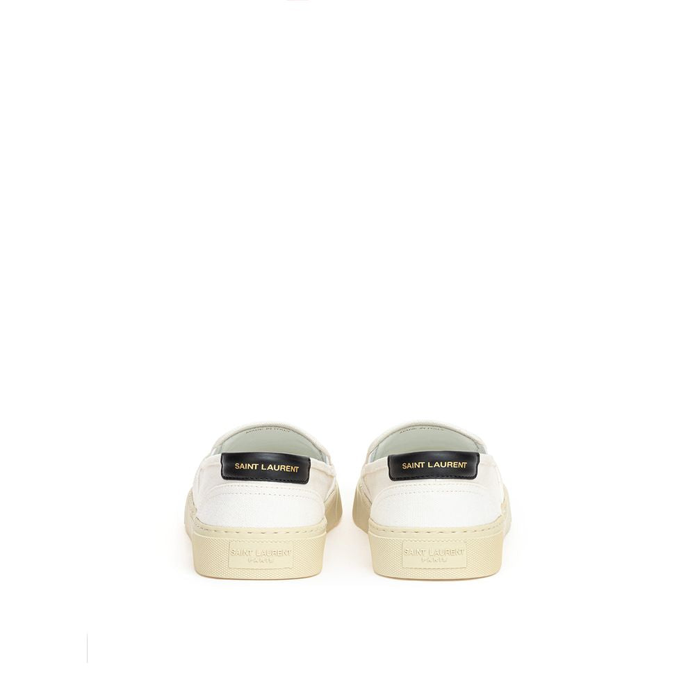 White Cotton Low Top SneakersWhite Canvas Slip-On Saint Laurent. Venice slip-on in cotton canvas, tone-on-tone rubber sole, round toe, black leather back tab with logo. Printed logo on the back. Sole height: 3 cm. Composition: 100% Cotton, leather interio