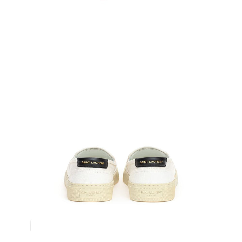 White Cotton Low Top SneakersWhite Canvas Slip-On Saint Laurent. Venice slip-on in cotton canvas, tone-on-tone rubber sole, round toe, black leather back tab with logo. Printed logo on the back. Sole height: 3 cm. Composition: 100% Cotton, leather interio