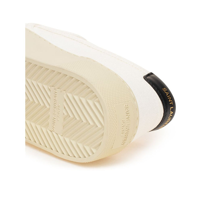 White Cotton Low Top SneakersWhite Canvas Slip-On Saint Laurent. Venice slip-on in cotton canvas, tone-on-tone rubber sole, round toe, black leather back tab with logo. Printed logo on the back. Sole height: 3 cm. Composition: 100% Cotton, leather interio