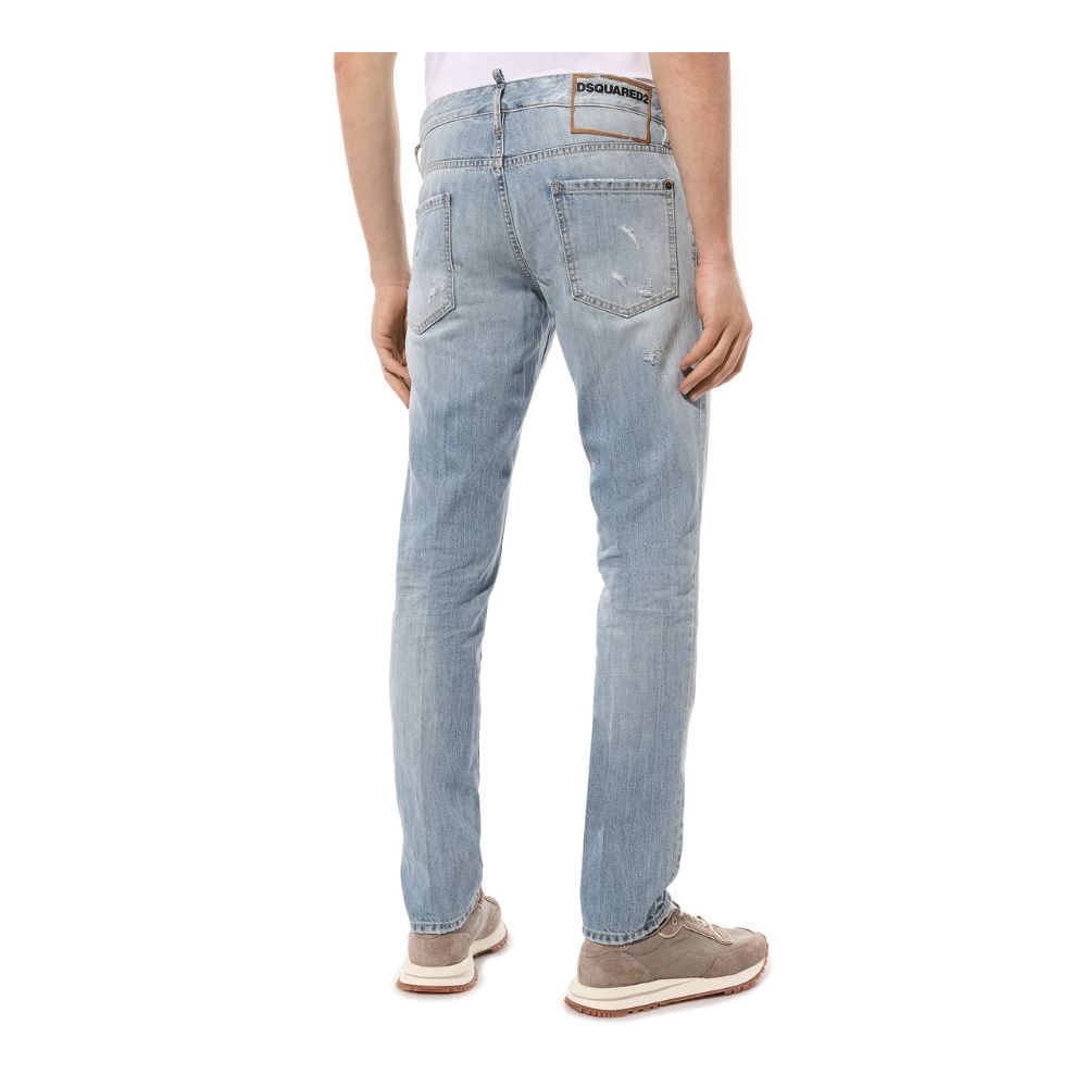 Blue Cotton Men JeansElevate your denim game with the edgy sophistication of Dsquared²’s light wash slim-fit jeans. Crafted with precision in Italy, these jeans feature an artful display of rips and distressed detailing for an effortlessly cool, worn-in l