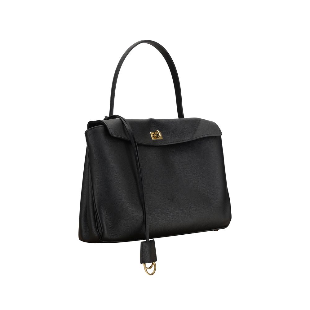 Black Calf Leather Bos Taurus Shoulder BagBalenciaga’s Rodeo Leather Shoulder Bag features a top handle for a comfortable and stylish grip. The front closure features a flap and swivel, adding a distinctive and functional detail. Applied keychain detail o