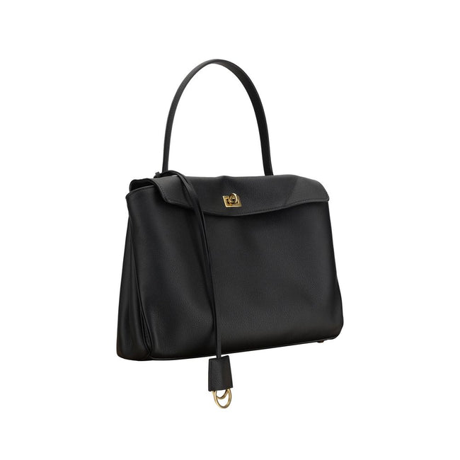 Black Calf Leather Bos Taurus Shoulder BagBalenciaga’s Rodeo Leather Shoulder Bag features a top handle for a comfortable and stylish grip. The front closure features a flap and swivel, adding a distinctive and functional detail. Applied keychain detail o