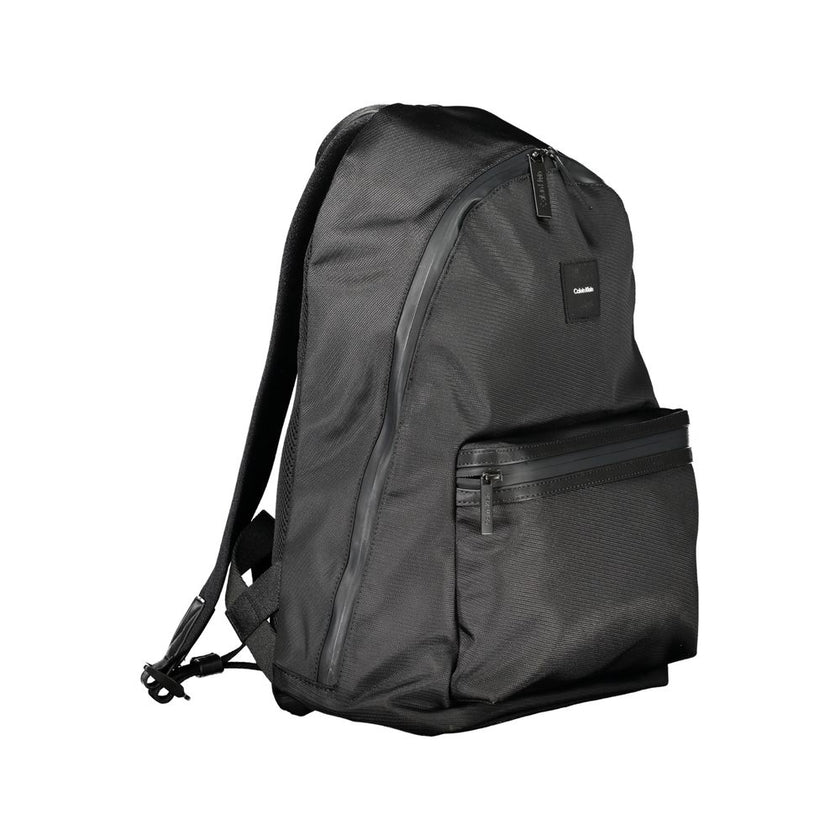 Black Polyester Men BackpackElevate your on-the-go gear with the Calvin Klein Backpack, designed to blend high fashion with practicality. A sleek black palette defines this accessory, underscored by an unmistakable logo, making it a stand-out piece. Craft