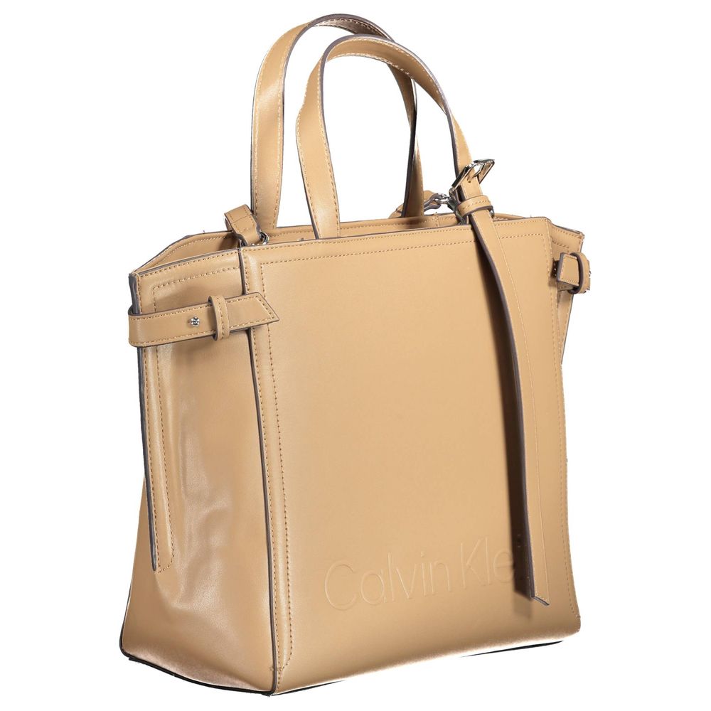 Brown Polyester Women HandbagElevate your accessory collection with the chic sophistication of this Calvin Klein handbag. Flaunting a sleek brown hue, it’s crafted for the conscious consumer from 51% polyester and 49% polyethylene, making a clear statemen