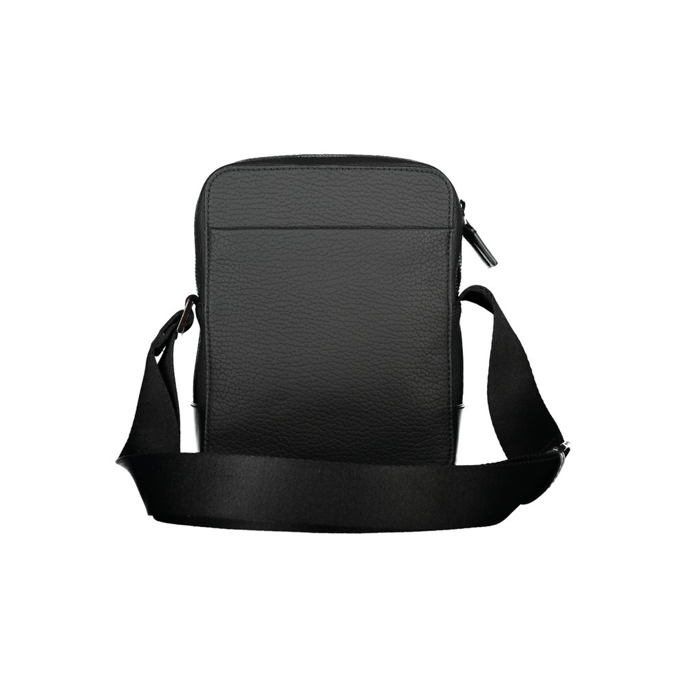 Sleek Black Shoulder Bag with Contrasting DetailsStep out in style with this sleek Calvin Klein shoulder bag, designed for the modern man. This bag boasts a practical adjustable strap for comfort, an external pocket for quick access, and a secure internal