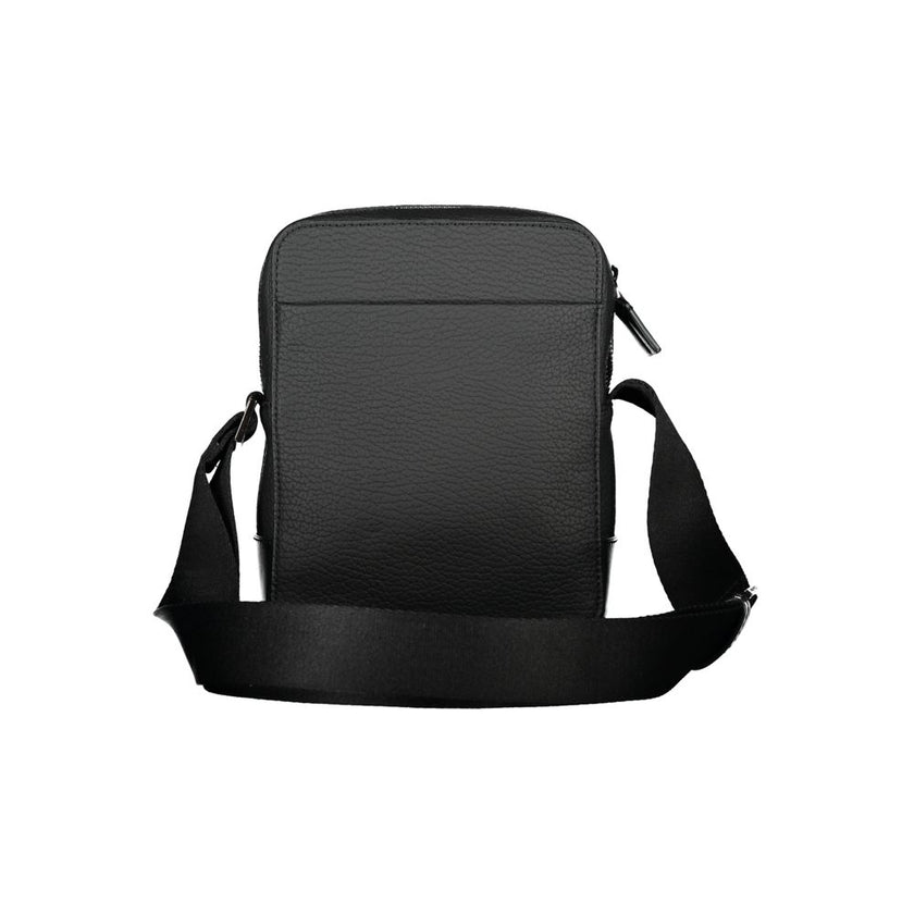 Sleek Black Shoulder Bag with Contrasting DetailsStep out in style with this sleek Calvin Klein shoulder bag, designed for the modern man. This bag boasts a practical adjustable strap for comfort, an external pocket for quick access, and a secure internal