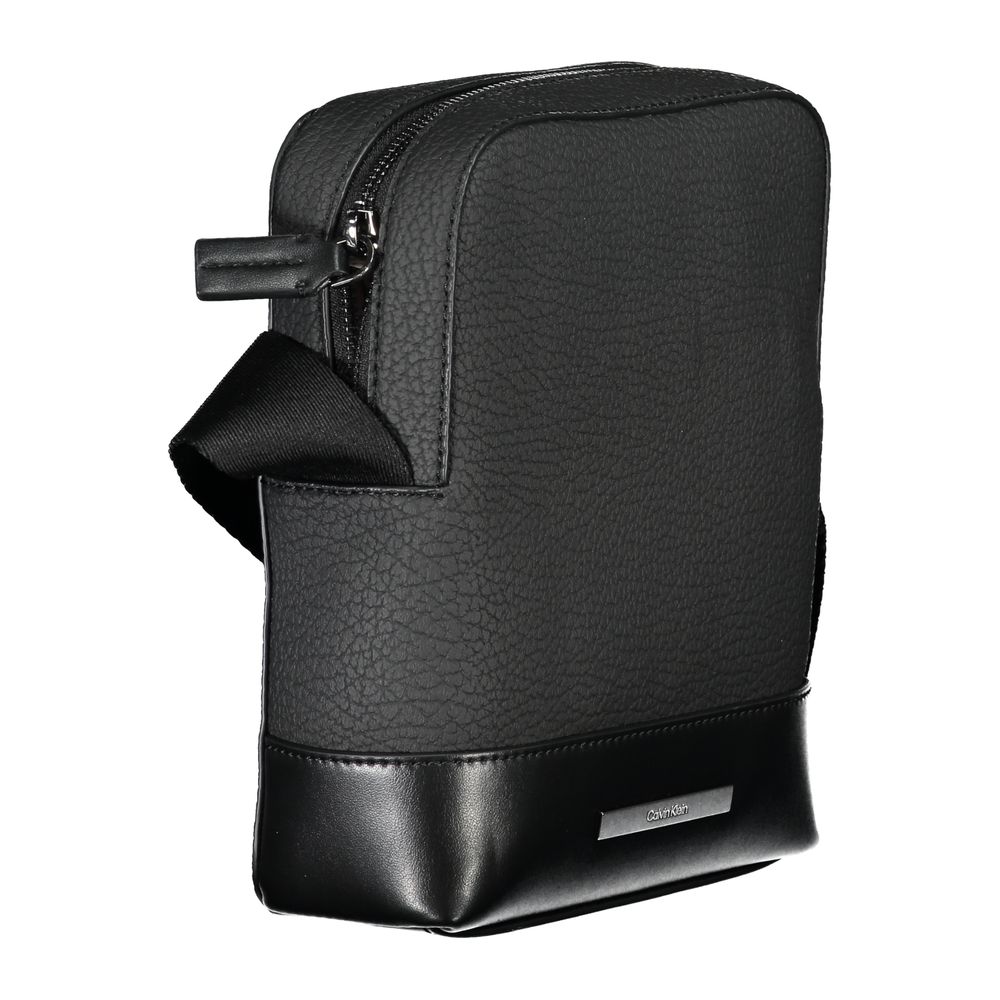 Sleek Black Shoulder Bag with Contrasting DetailsStep out in style with this sleek Calvin Klein shoulder bag, designed for the modern man. This bag boasts a practical adjustable strap for comfort, an external pocket for quick access, and a secure internal