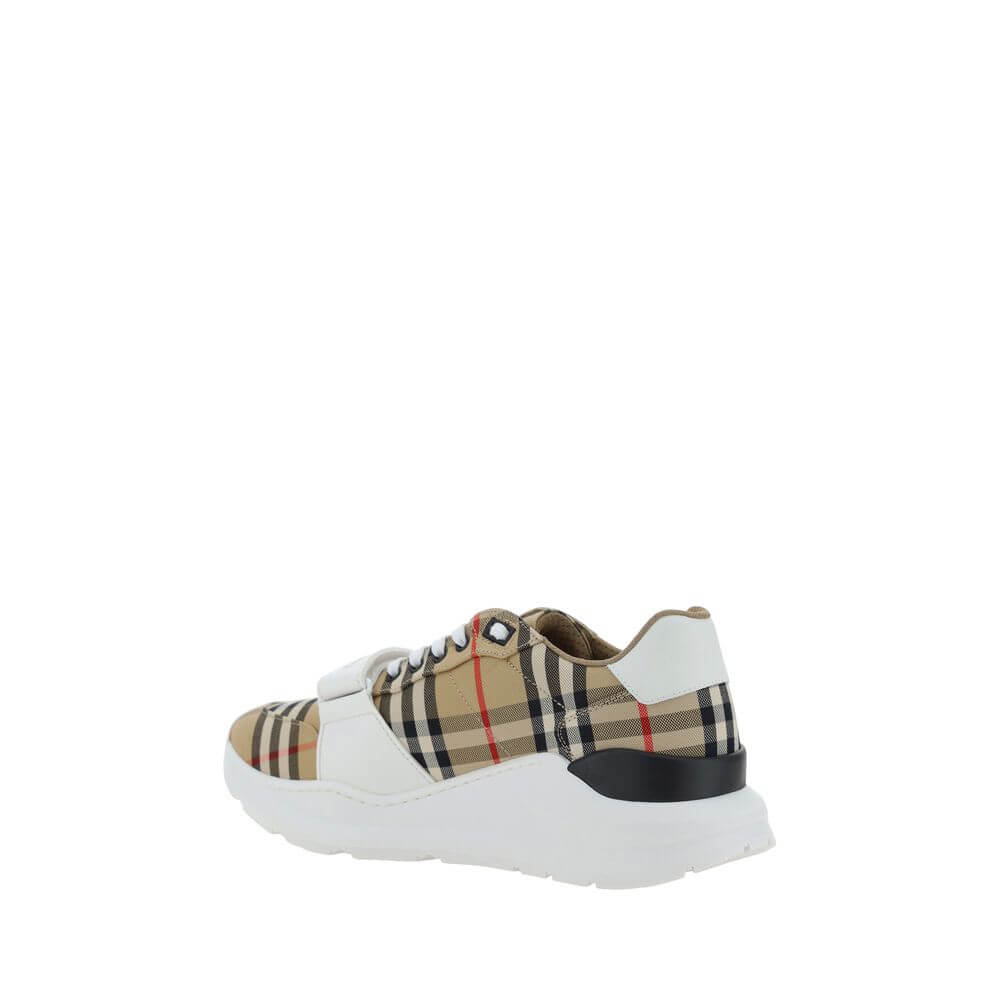 Beige Rubber SneakersNew Regis Sneakers by Burberry, slightly elongated toe, lace-up front closure, Velcro strap detail on front, iconic all-over repeated Check Archive brand pattern, contrasting brand signature on back. Season: AW25 Composition: SOLE 100