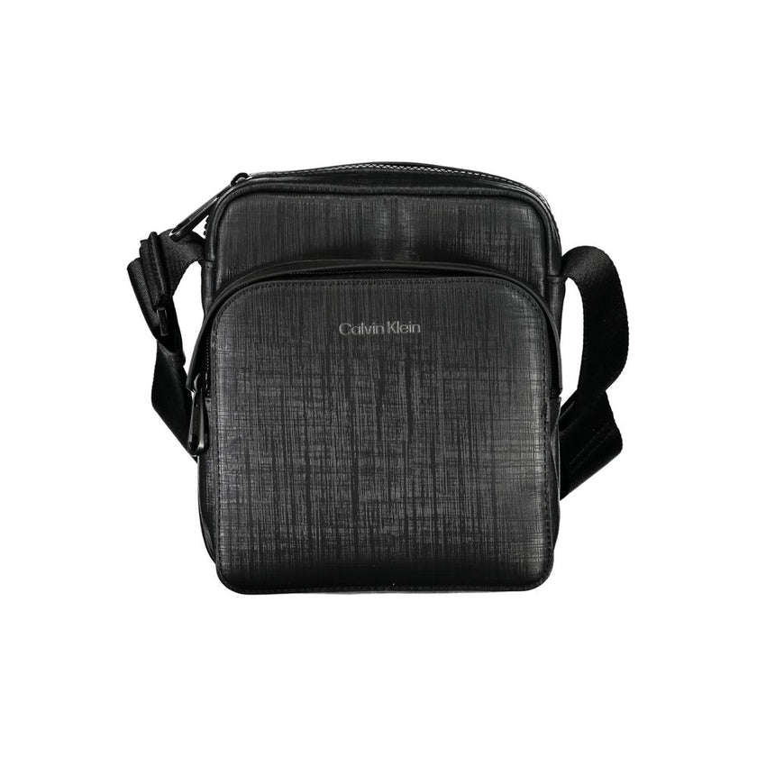 Elegant Black Shoulder Bag with Contrasting DetailsExude sophistication with this sleek Calvin Klein shoulder bag, perfect for the modern man on-the-go. Featuring an adjustable shoulder strap for comfort, an external pocket for quick access essentials, an