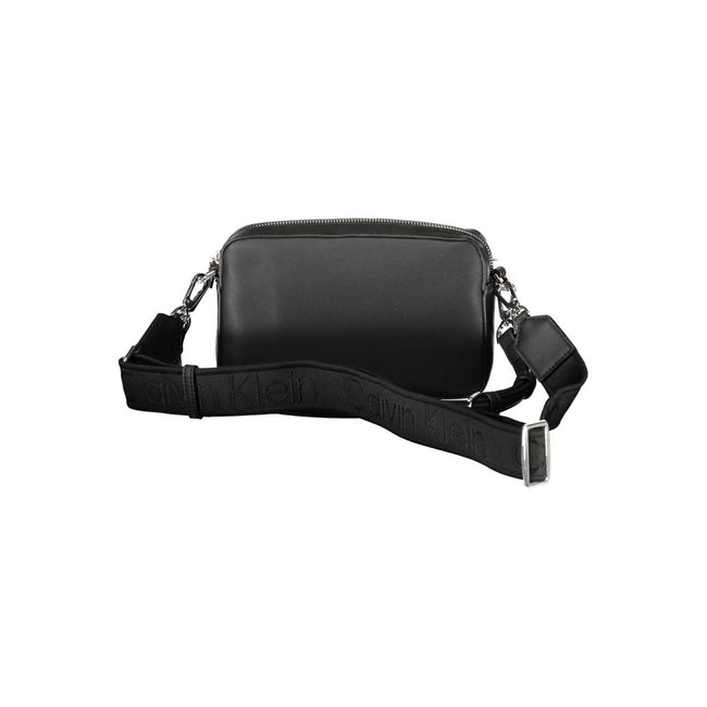 Black Polyester Women HandbagExperience the epitome of urban chic with Calvin Klein’s latest handbag creation. Designed for the modern fashionista, this sleek black bag boasts functionality and style. Featuring one removable shoulder handle and an adjusta
