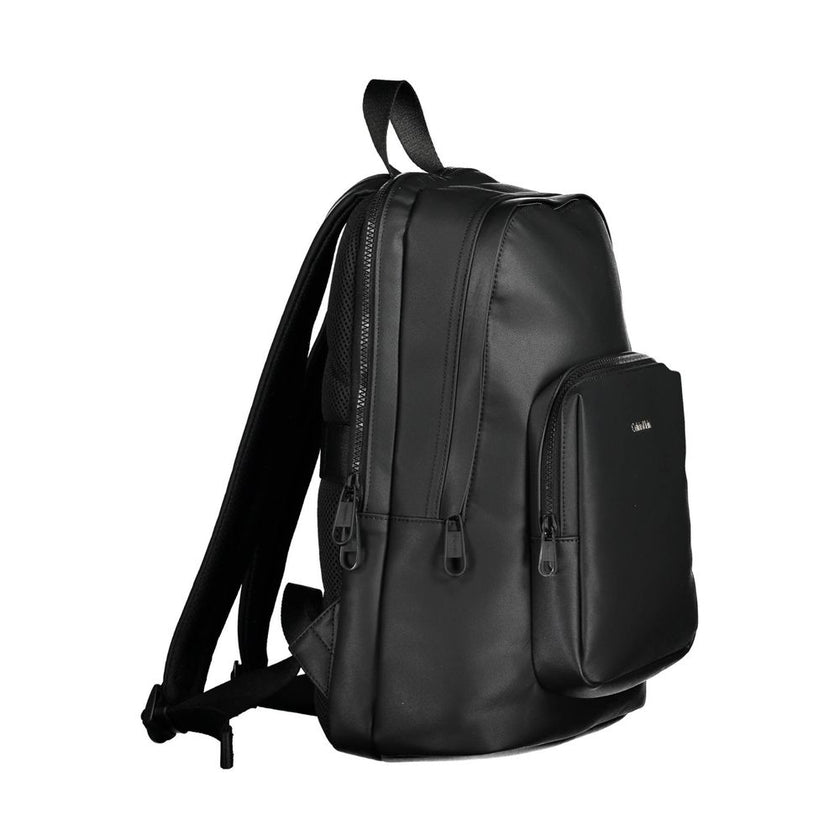 Black Polyester Men BackpackElevate your on-the-go style with the Calvin Klein Essential Backpack, a blend of functionality and eco-friendly fashion. Crafted with 50% recycled materials, this sleek black accessory is a testament to modern design and susta