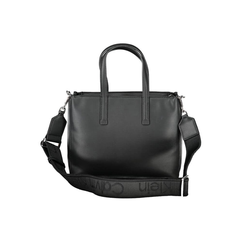 Black Polyester Women HandbagUnleash the epitome of urban-chic with the Calvin Klein masterpiece that seamlessly blends sustainability with style. Imagine the touch of sophistication with a bag that boasts dual handles for sheer elegance, a versatile adju