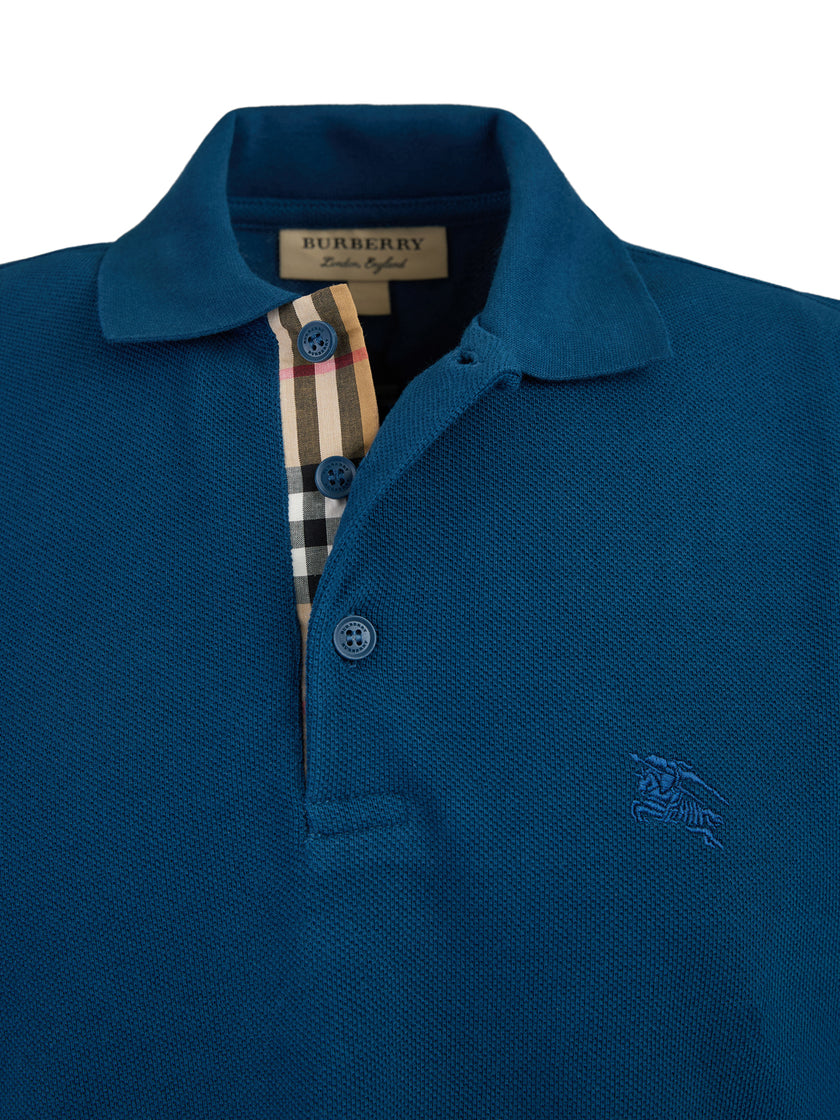 Deep Teal Blue Cotton Collared Polo ShirtBURBERRY Gorgeous brand new, Deep Teal Blue Cotton Collared Polo Shirt Art#: 8004352 Model: Short sleeve Polo Shirt Colour: Deep Teal Blue Material: 100% Cotton Fitting: Regular Fit Logo details Made in ThailandDee