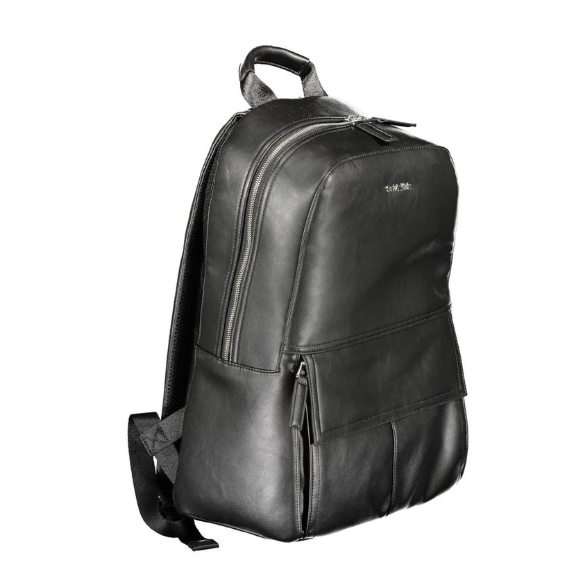Black Polyester Men BackpackElevate your on-the-go style with the Calvin Klein Backpack, designed for the modern urban explorer. Featuring a sleek black exterior, this backpack is crafted with practicality and superior design in mind. The one handle and c