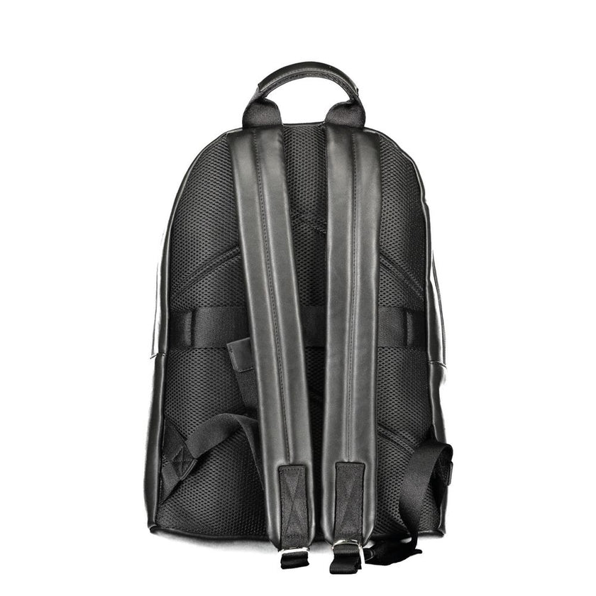Black Polyester Men BackpackElevate your on-the-go style with the Calvin Klein Backpack, designed for the modern urban explorer. Featuring a sleek black exterior, this backpack is crafted with practicality and superior design in mind. The one handle and c