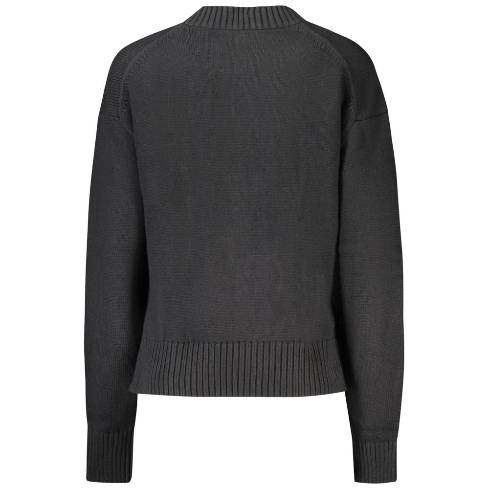 Black Cotton Women SweaterElevate your wardrobe with the quintessence of sophistication – the Calvin Klein Long-Sleeved Sweater. Crafted from a premium blend of cotton and wool, this high neck gem offers comfort with a dash of luxury. Featuring an elegant