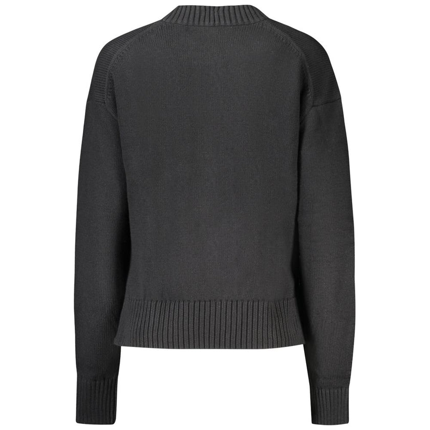 Black Cotton Women SweaterElevate your wardrobe with the quintessence of sophistication – the Calvin Klein Long-Sleeved Sweater. Crafted from a premium blend of cotton and wool, this high neck gem offers comfort with a dash of luxury. Featuring an elegant