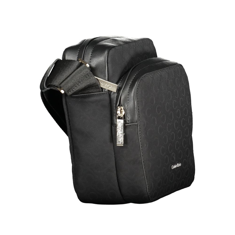 Black Polyester Men Shoulder BagElevate your accessory game with the sleek Calvin Klein shoulder bag, where functionality meets refined style. This bag is designed for the modern man on-the-go, featuring a durable build with a sharp black finish that comm