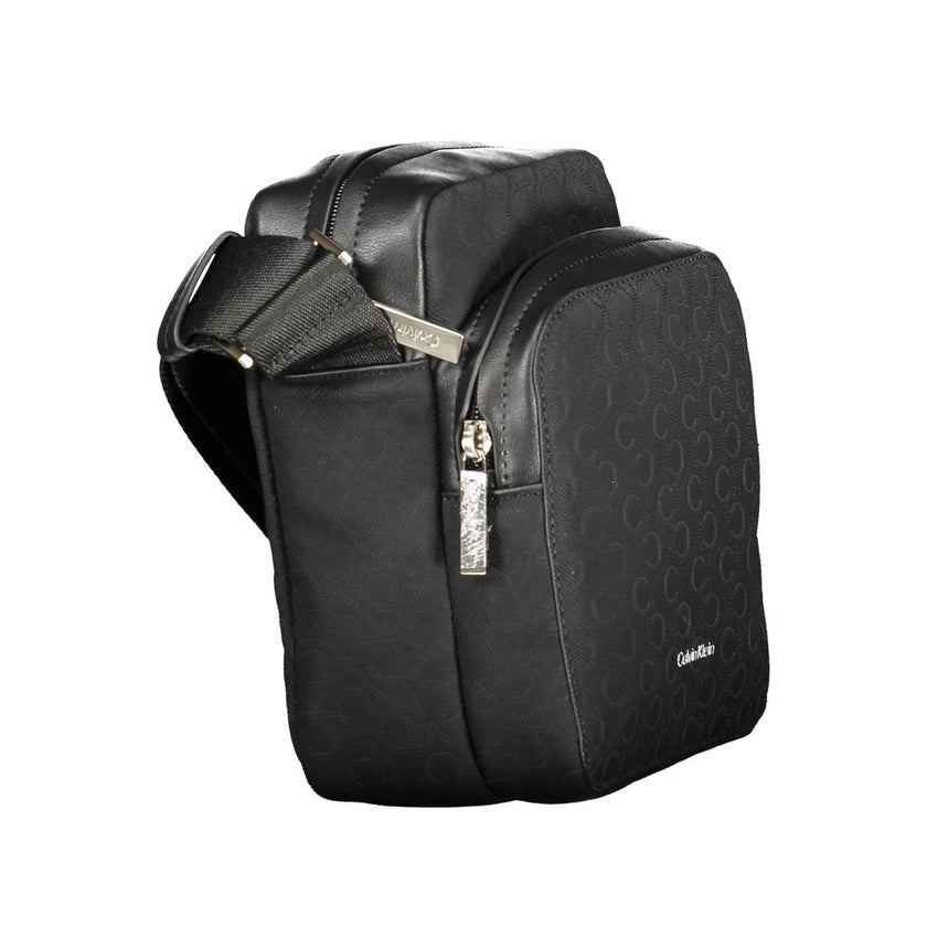Black Polyester Men Shoulder BagElevate your accessory game with the sleek Calvin Klein shoulder bag, where functionality meets refined style. This bag is designed for the modern man on-the-go, featuring a durable build with a sharp black finish that comm
