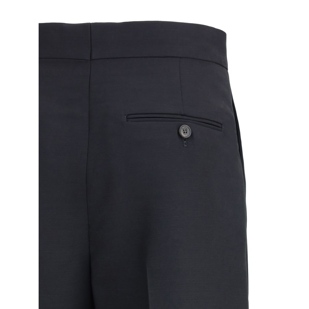 Black Viscose Casual PantsFerragamo’s tailored Pants exemplify elegance and handcrafted perfection. Featuring a straight front pleat pattern, these pants offer a refined silhouette and an impeccable fit. The front zip-and-hook closure ensures a secure and