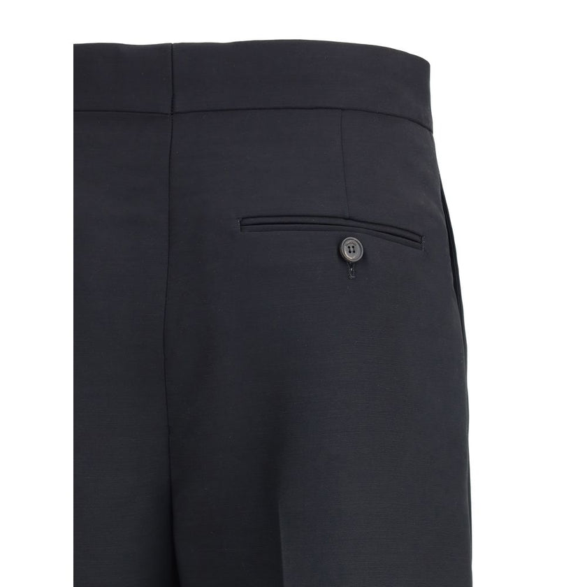 Black Viscose Casual PantsFerragamo’s tailored Pants exemplify elegance and handcrafted perfection. Featuring a straight front pleat pattern, these pants offer a refined silhouette and an impeccable fit. The front zip-and-hook closure ensures a secure and