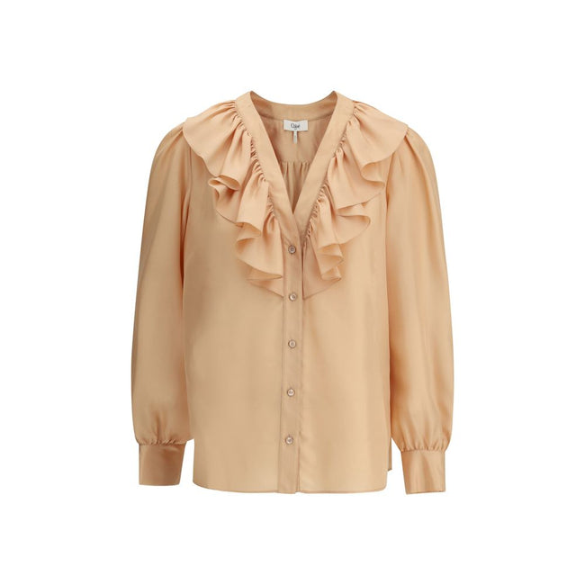 Ruffle ShirtChloé’s Habotai Silk Ruffle Shirt by Chloé is a romantic and sophisticated piece, perfect for adding an ethereal touch to your wardrobe. Featuring a V-neckline and a delicate row of ruffles on the front, it expresses femininity with lightness