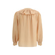 Ruffle ShirtChloé’s Habotai Silk Ruffle Shirt by Chloé is a romantic and sophisticated piece, perfect for adding an ethereal touch to your wardrobe. Featuring a V-neckline and a delicate row of ruffles on the front, it expresses femininity with lightness