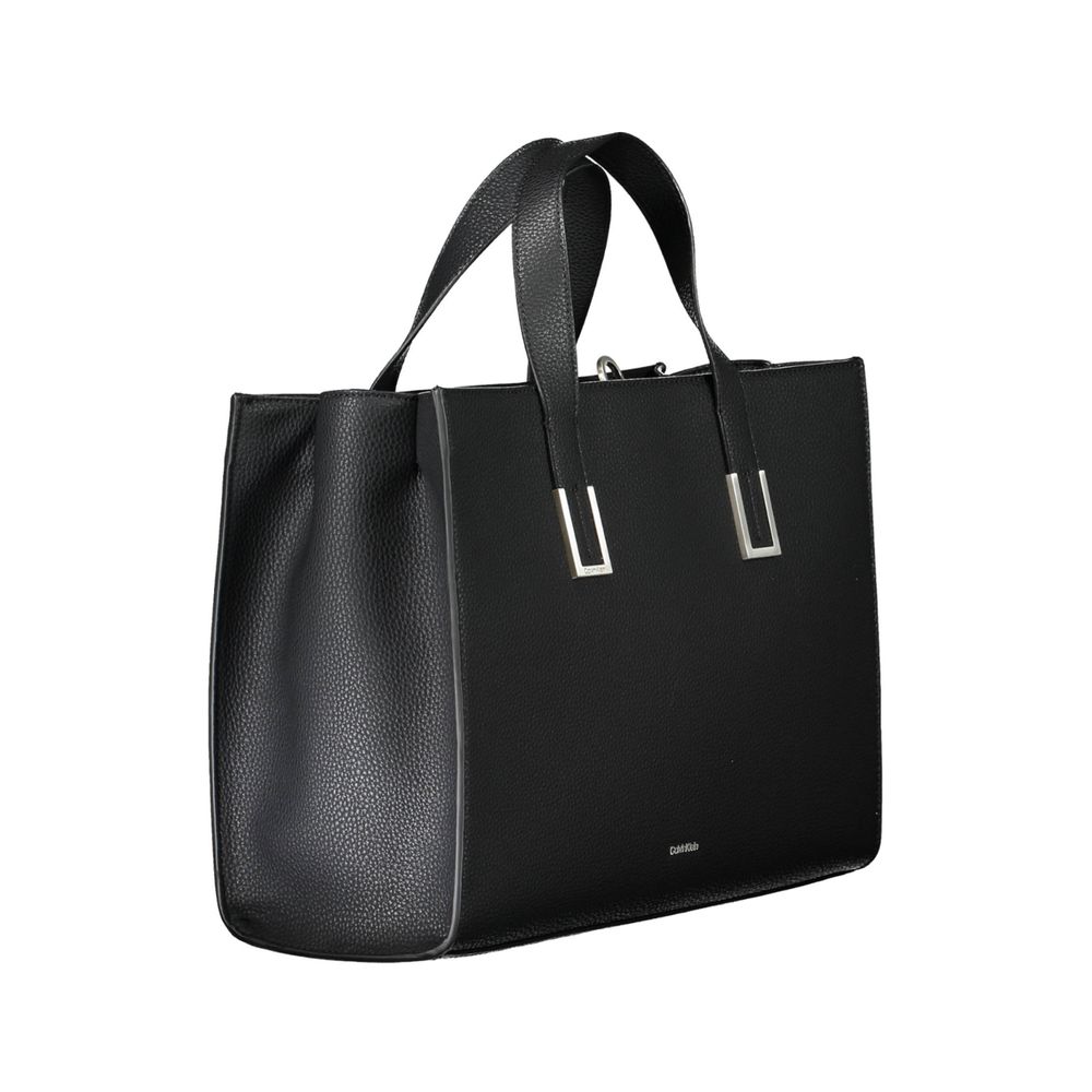 Black Polyester Women HandbagElevate your accessory game with this Calvin Klein masterpiece, where eco-conscious luxury meets functional elegance. This black handbag boasts a sophisticated design with two handles, an adjustable and removable shoulder stra