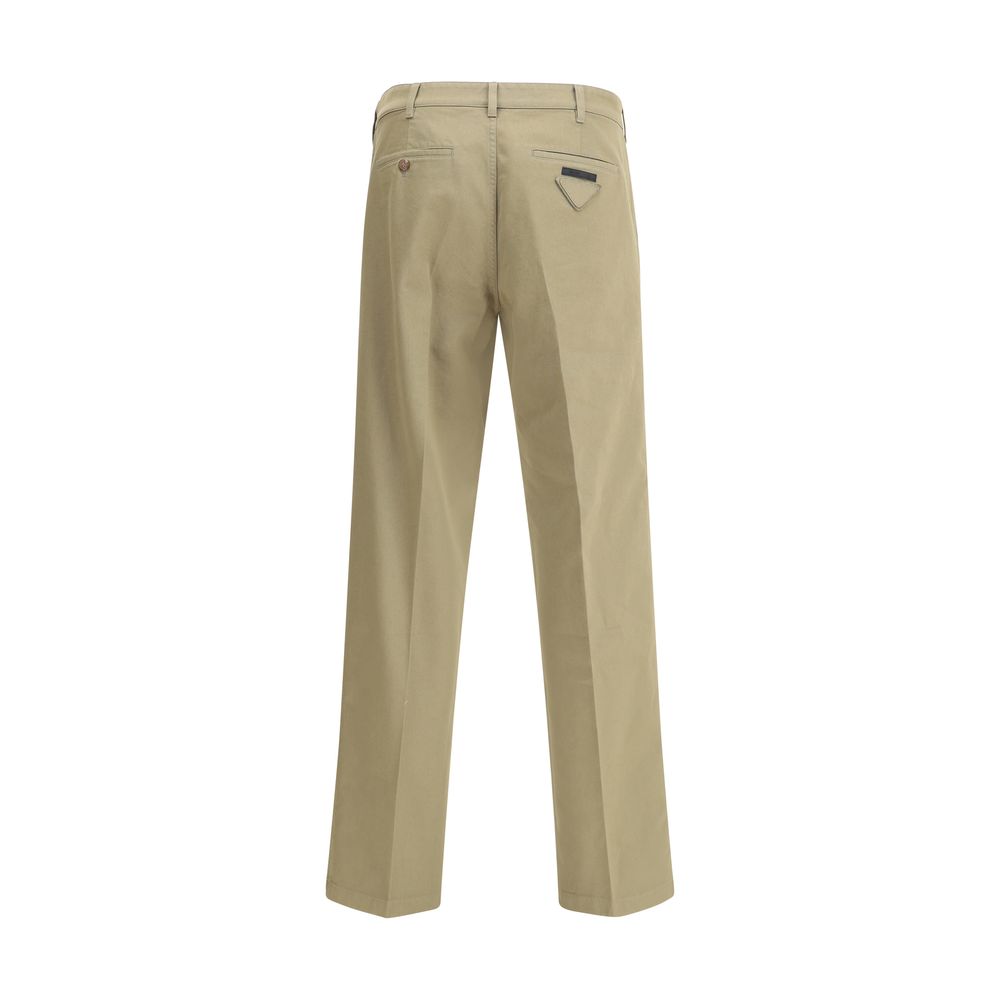 Beige Cotton Chino PantsPrada’s chino Pants offer essential elegance with contemporary style. Featuring a front zipper and button closure, they feature two side welt pockets and back pockets, one of which is embellished with the brand’s iconic logo. Waist