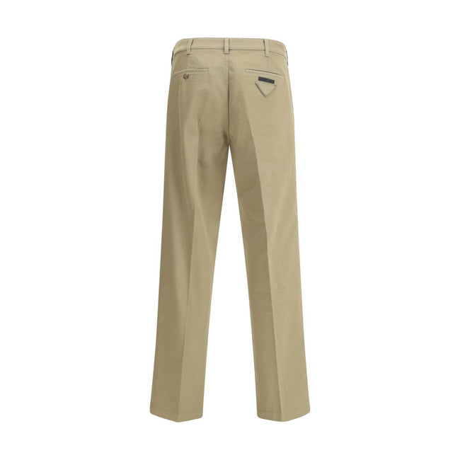 Beige Cotton Chino PantsPrada’s chino Pants offer essential elegance with contemporary style. Featuring a front zipper and button closure, they feature two side welt pockets and back pockets, one of which is embellished with the brand’s iconic logo. Waist