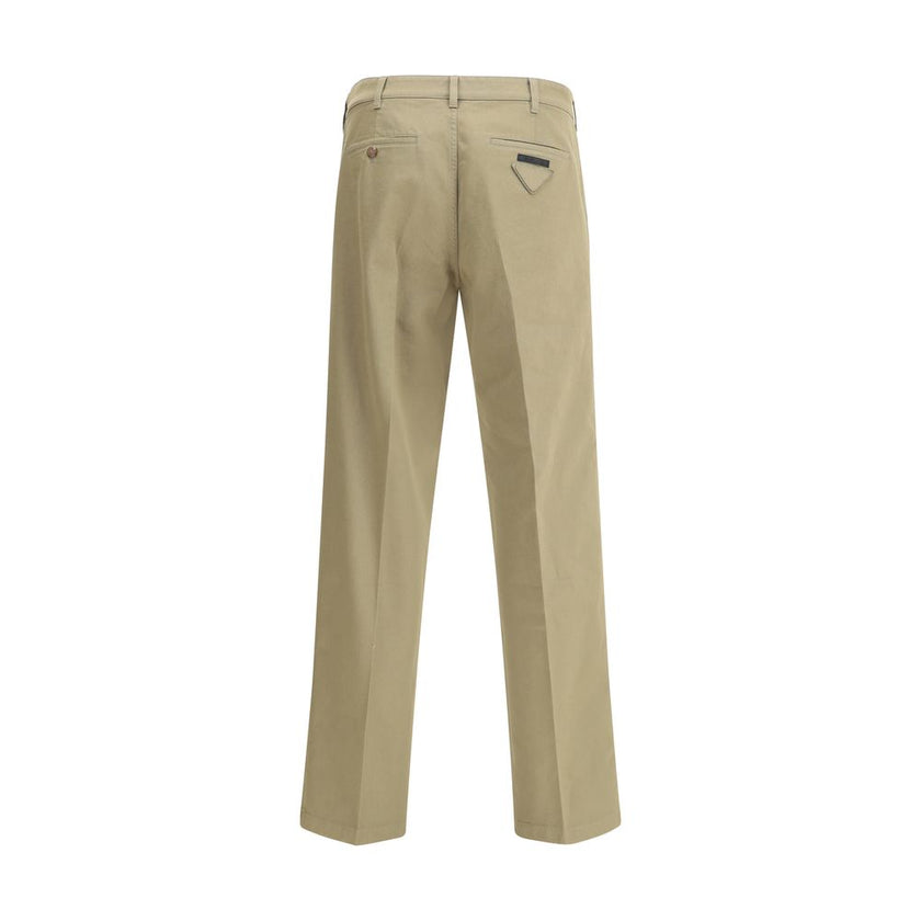 Beige Cotton Chino PantsPrada’s chino Pants offer essential elegance with contemporary style. Featuring a front zipper and button closure, they feature two side welt pockets and back pockets, one of which is embellished with the brand’s iconic logo. Waist