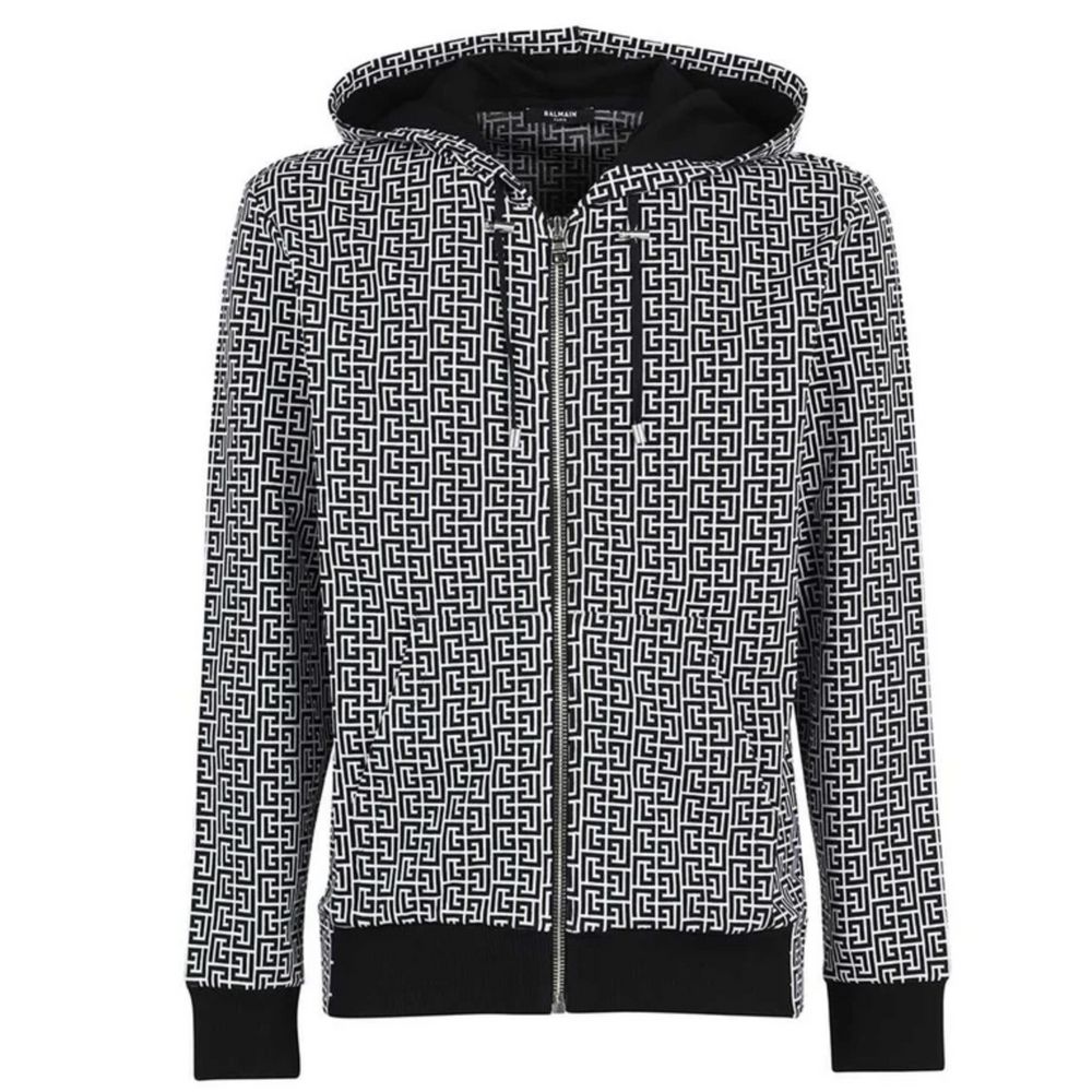 Black Cotton Men's SweaterUnleash your inner fashionista with the striking Balmain Monogram Hooded Sweatshirt. Exuding edge and luxury, it’s a not-so-subtle nod to high fashion with its iconic monogram print. Crafted in Italy, this cotton masterpiece feat