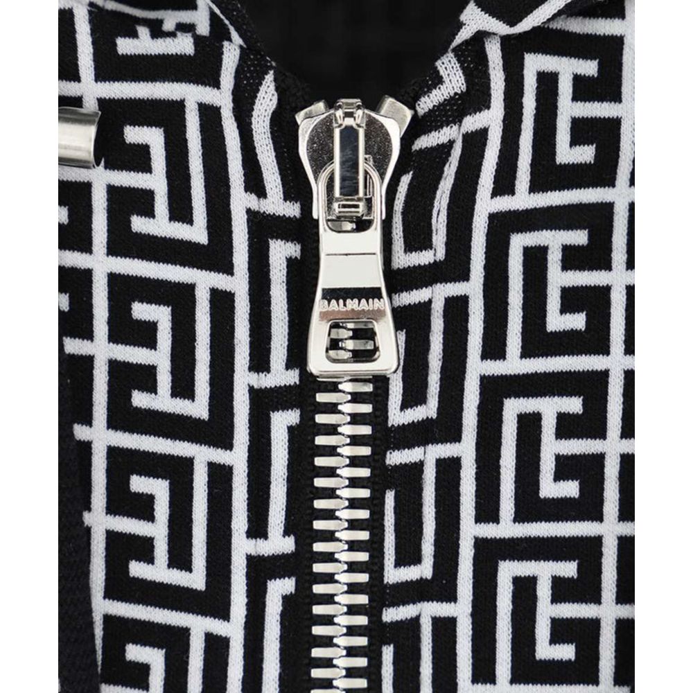 Black Cotton Men's SweaterUnleash your inner fashionista with the striking Balmain Monogram Hooded Sweatshirt. Exuding edge and luxury, it’s a not-so-subtle nod to high fashion with its iconic monogram print. Crafted in Italy, this cotton masterpiece feat