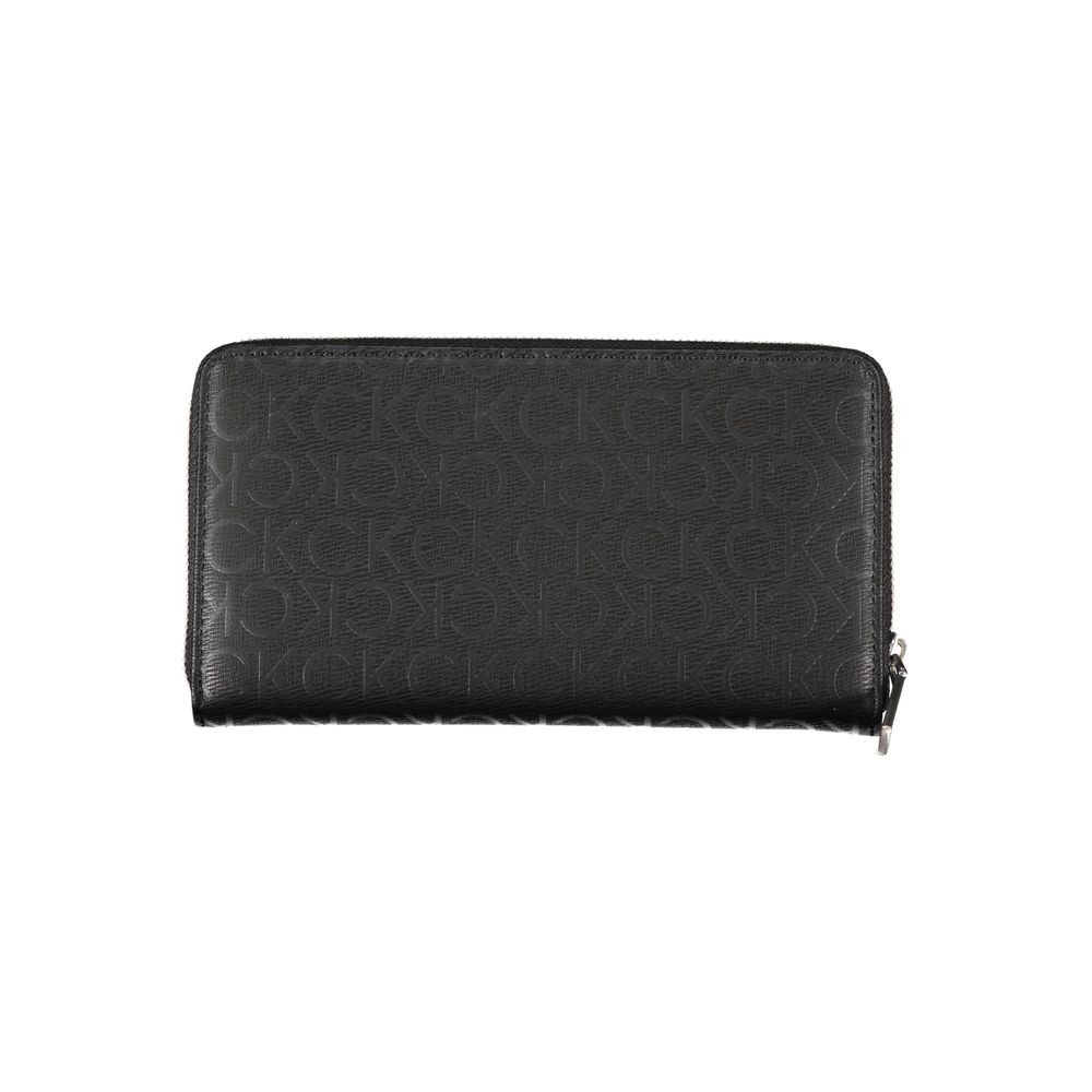Sleek Designer Three-Compartment WalletImmerse in sophistication with this sleek wallet from Calvin Klein, crafted for the modern individual. Staying organized is effortless with three well-designed compartments, complemented by a handy coin purse and ded