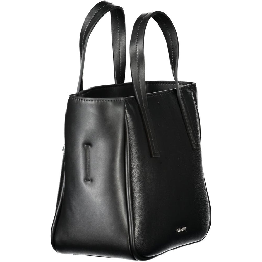 Black Polyethylene Women HandbagElevate your accessory game with this sleek Calvin Klein handbag, a statement piece blending utility and style. Crafted with a modern mixture of 33% Polyester and 67% Polyethylene, this exquisite black bag boasts two handle
