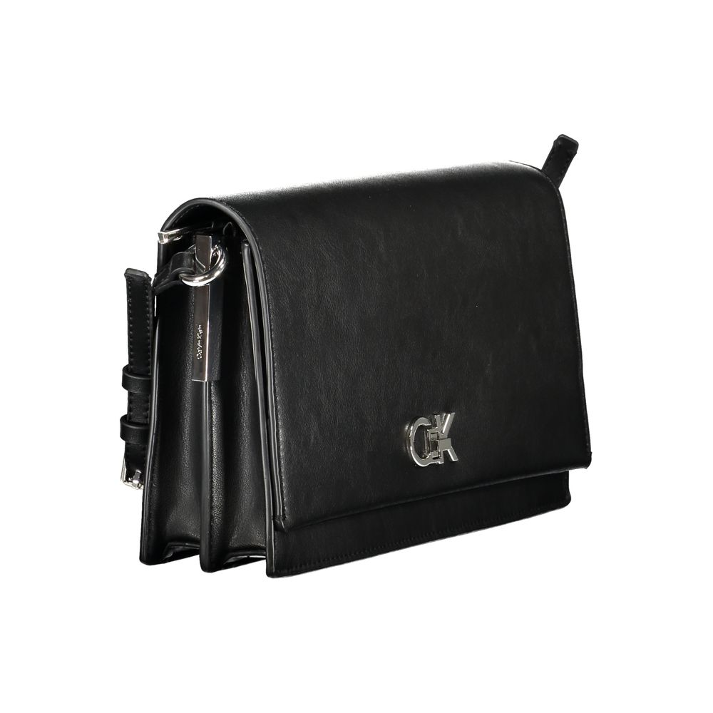 Black Polyester Women HandbagExperience the pinnacle of urban sophistication with this Calvin Klein masterpiece. Crafted for the eco-conscious fashionista, this sleek bag marries functionality with high-end style, featuring an adjustable shoulder handle a