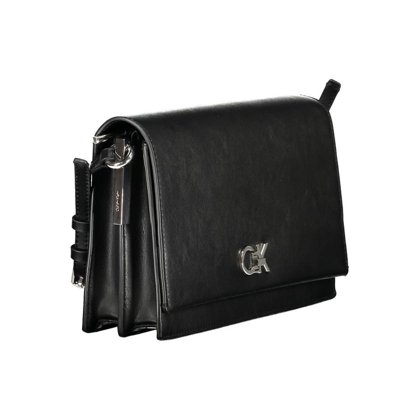 Black Polyester Women HandbagExperience the pinnacle of urban sophistication with this Calvin Klein masterpiece. Crafted for the eco-conscious fashionista, this sleek bag marries functionality with high-end style, featuring an adjustable shoulder handle a
