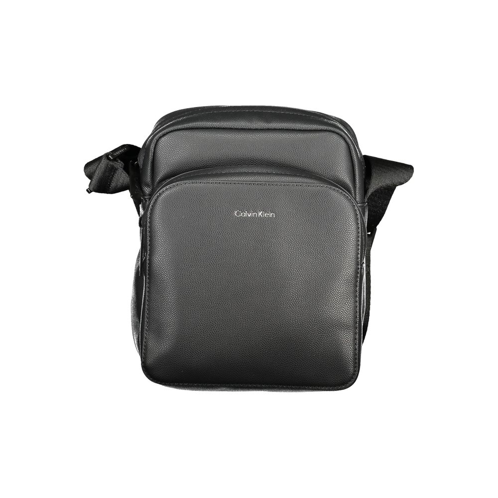 Black Polyester Men Shoulder BagElevate your accessory game with the Calvin Klein shoulder bag—a seamless blend of function and style. Flaunting a sleek black hue, this versatile piece features an adjustable strap for personalized comfort, an exterior poc