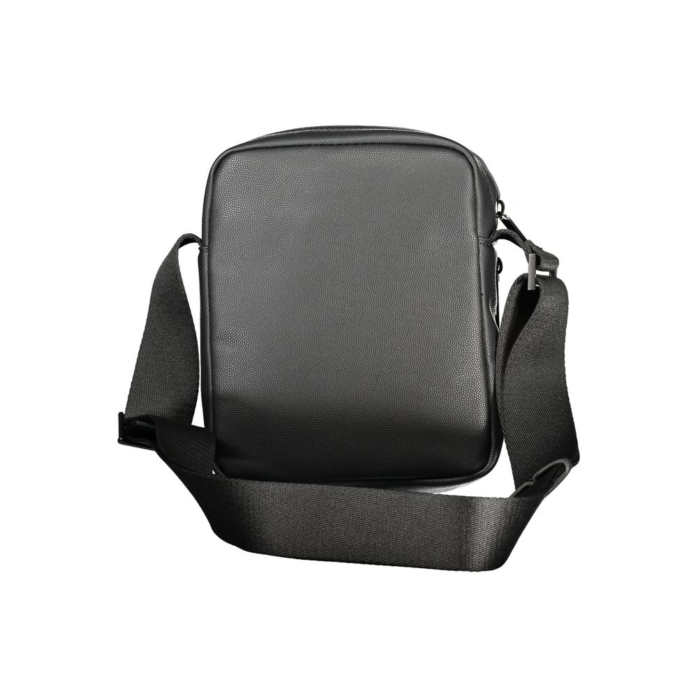Black Polyester Men Shoulder BagElevate your accessory game with the Calvin Klein shoulder bag—a seamless blend of function and style. Flaunting a sleek black hue, this versatile piece features an adjustable strap for personalized comfort, an exterior poc