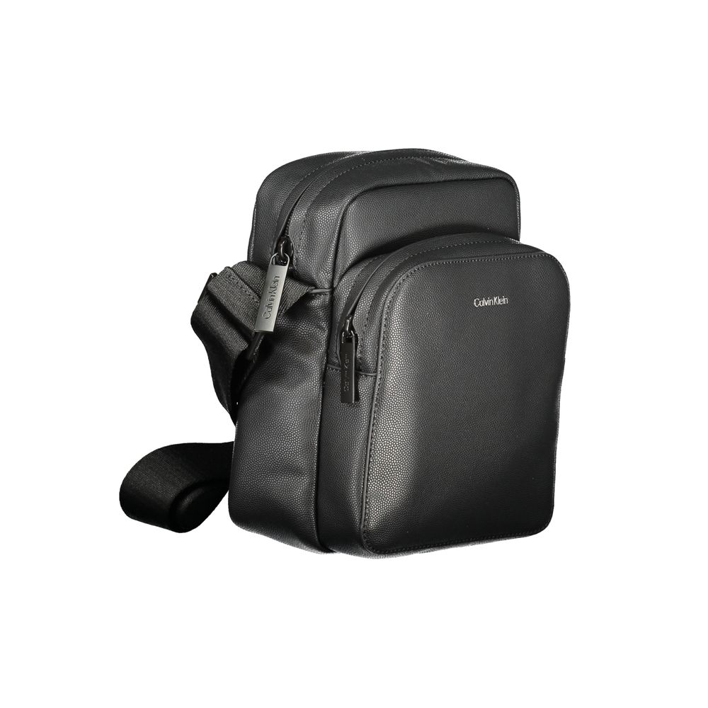 Black Polyester Men Shoulder BagElevate your accessory game with the Calvin Klein shoulder bag—a seamless blend of function and style. Flaunting a sleek black hue, this versatile piece features an adjustable strap for personalized comfort, an exterior poc