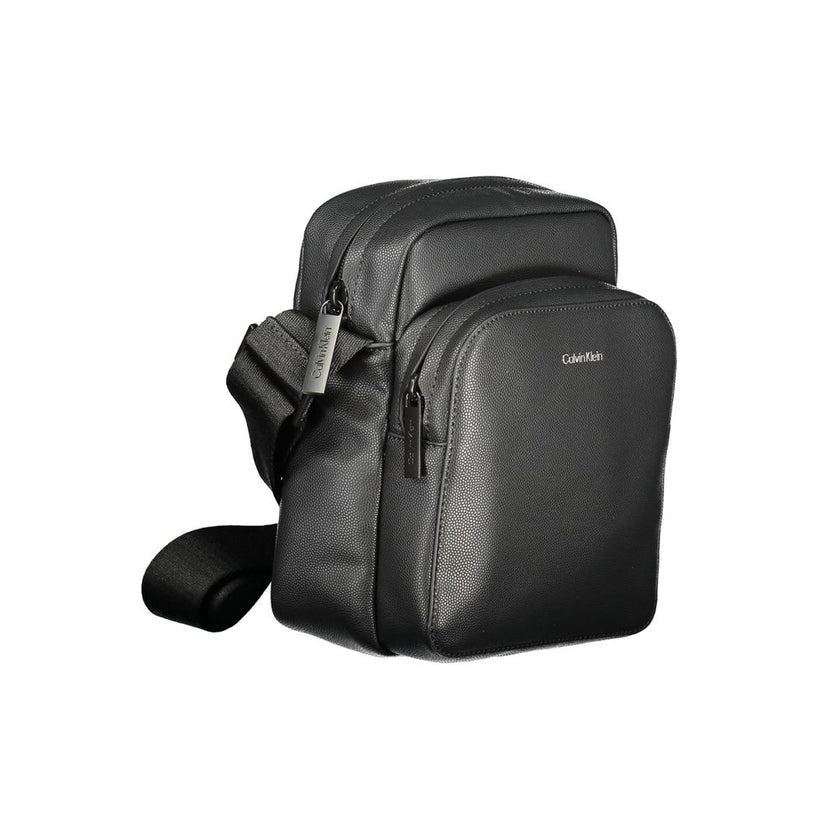Black Polyester Men Shoulder BagElevate your accessory game with the Calvin Klein shoulder bag—a seamless blend of function and style. Flaunting a sleek black hue, this versatile piece features an adjustable strap for personalized comfort, an exterior poc