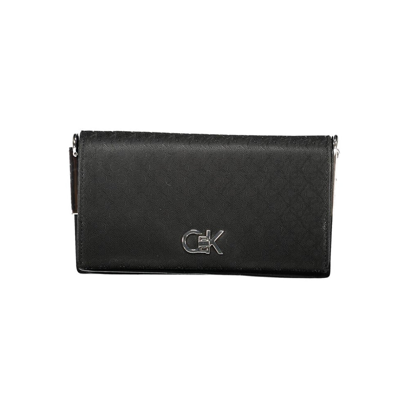 Black Polyester Women HandbagElevate your accessory game with this chic Calvin Klein shoulder bag. Designed to cater to both style and functionality, it flaunts two spacious compartments, a secure central pocket, and a card-formed pocket for your essentia