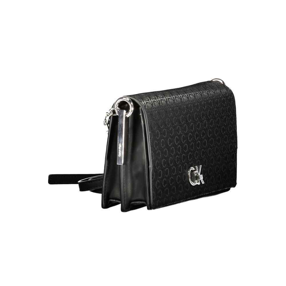 Black Polyester Women HandbagElevate your accessory game with this chic Calvin Klein shoulder bag. Designed to cater to both style and functionality, it flaunts two spacious compartments, a secure central pocket, and a card-formed pocket for your essentia